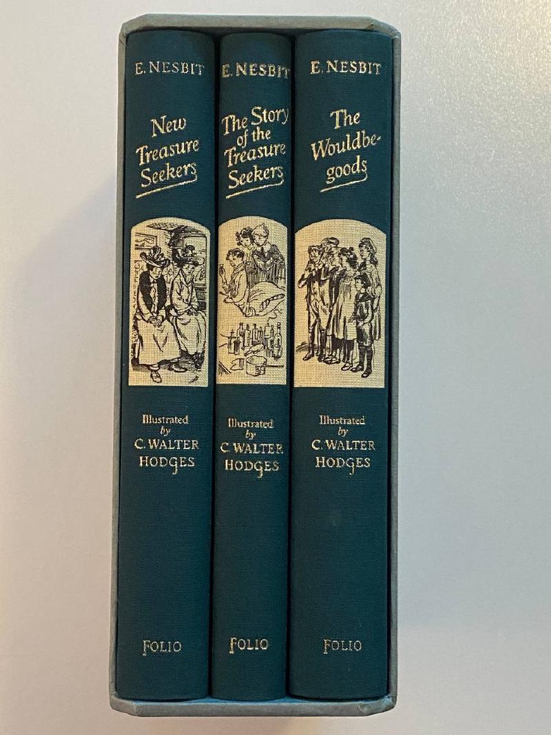 The gilt-lettered spines of all three E. Nesbit volumes inside the slipcase.